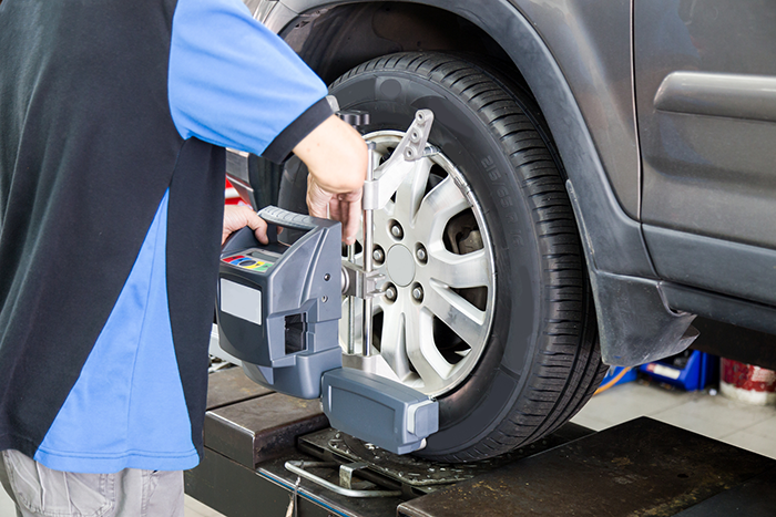 Mechanic Carrying out a wheel alignment